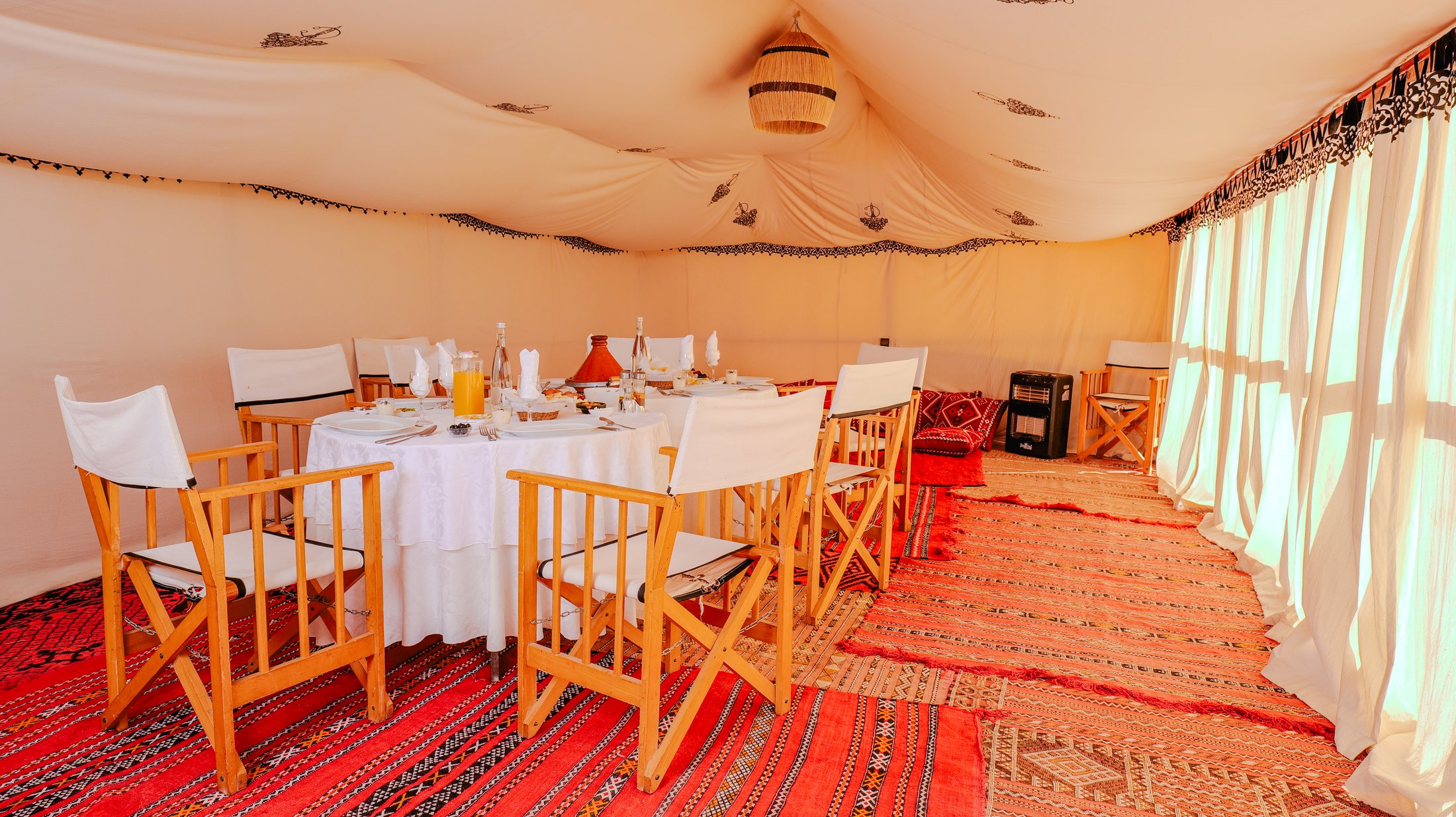 Moroccan dining tent interior at Golden Dune Luxury Camp
