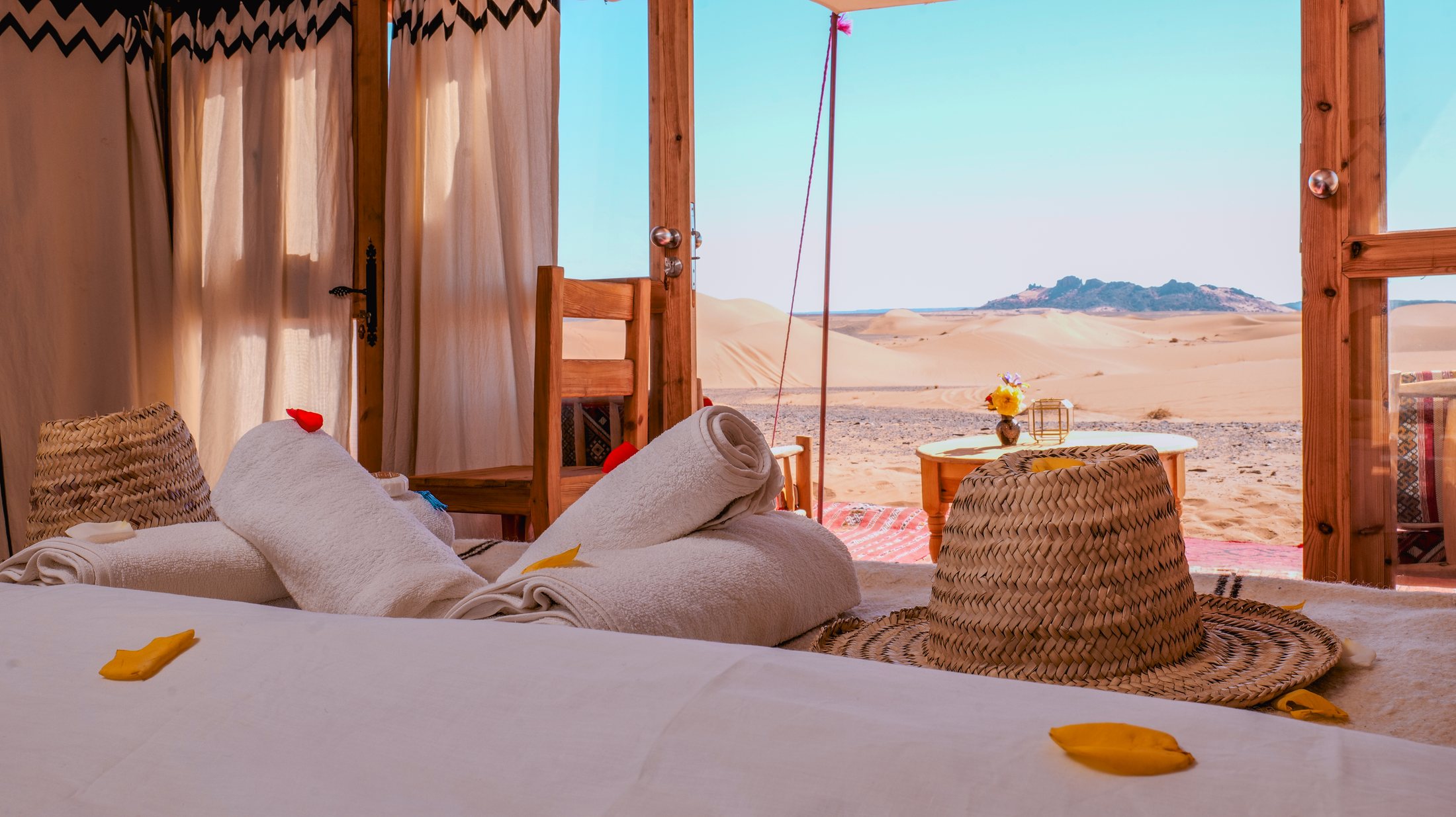 Private tent interior opening toward the Sahara dunes