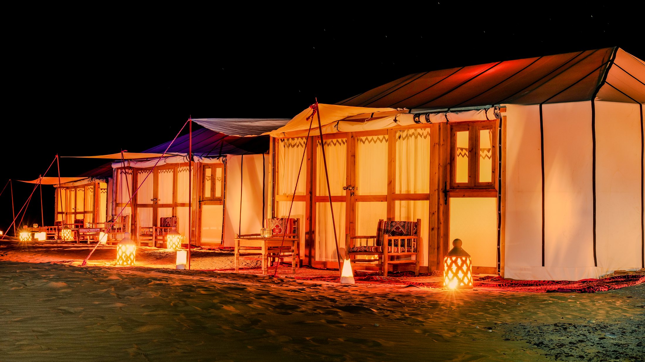 Exterior row of desert tents at Golden Dune Luxury Camp